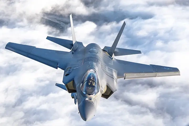 Supplied contextual image of a military aircraft above clouds.