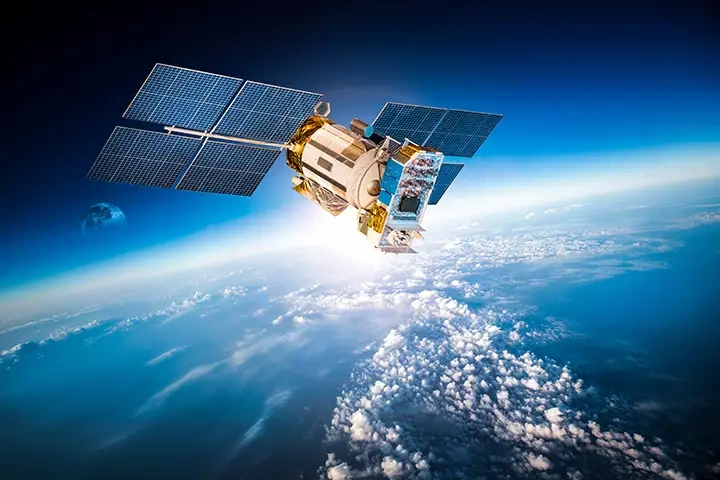 Supplied illustration of a satellite with solar panels above Earth.