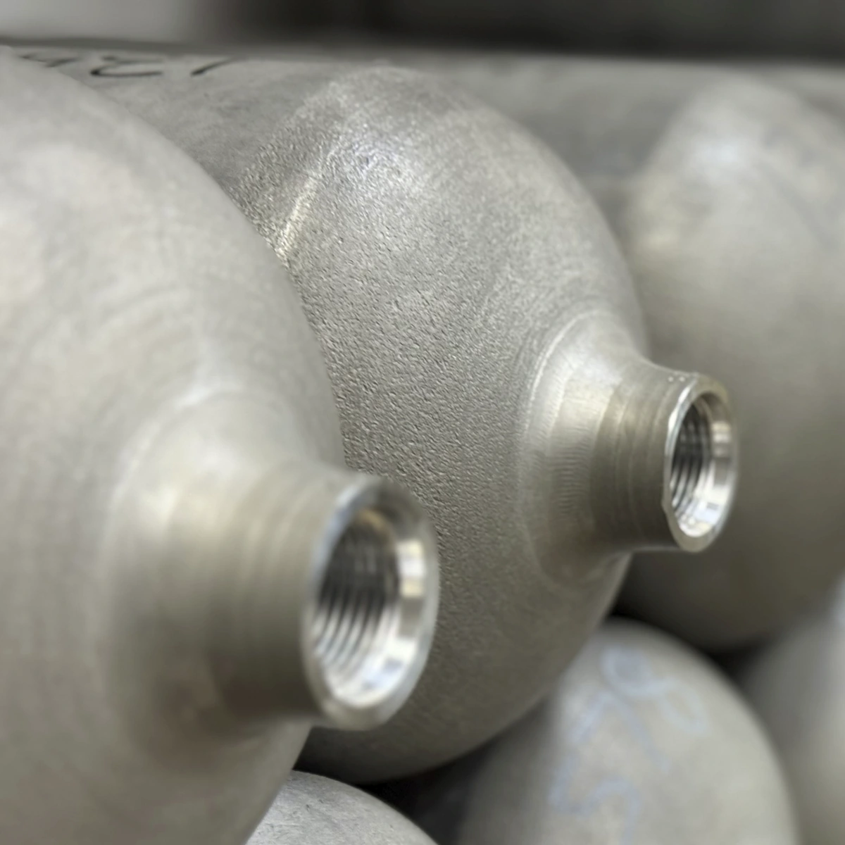 Close-up of threaded ports on Atlas Series Type I aluminum vessels