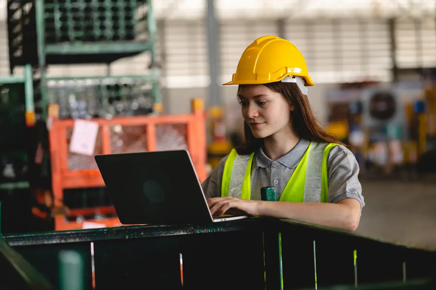 Engineer reviewing certification data on a laptop, ensuring complete documentation of test results, inspection reports, and compliance records.