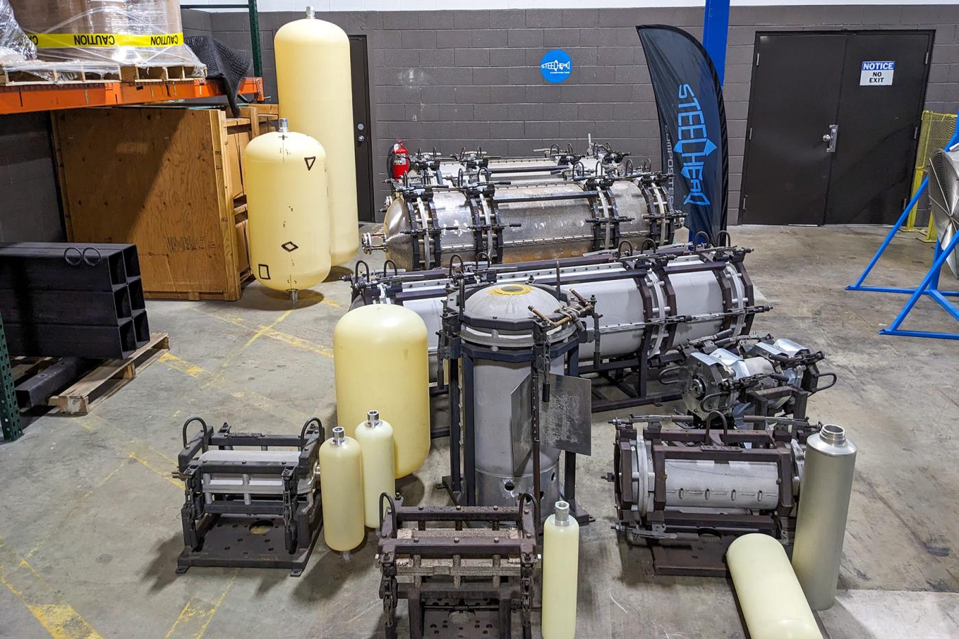 Various Type IV polymer liners and metal molds in different sizes displayed inside the Advanced Liner Fabrication facility at Steelhead Composites.