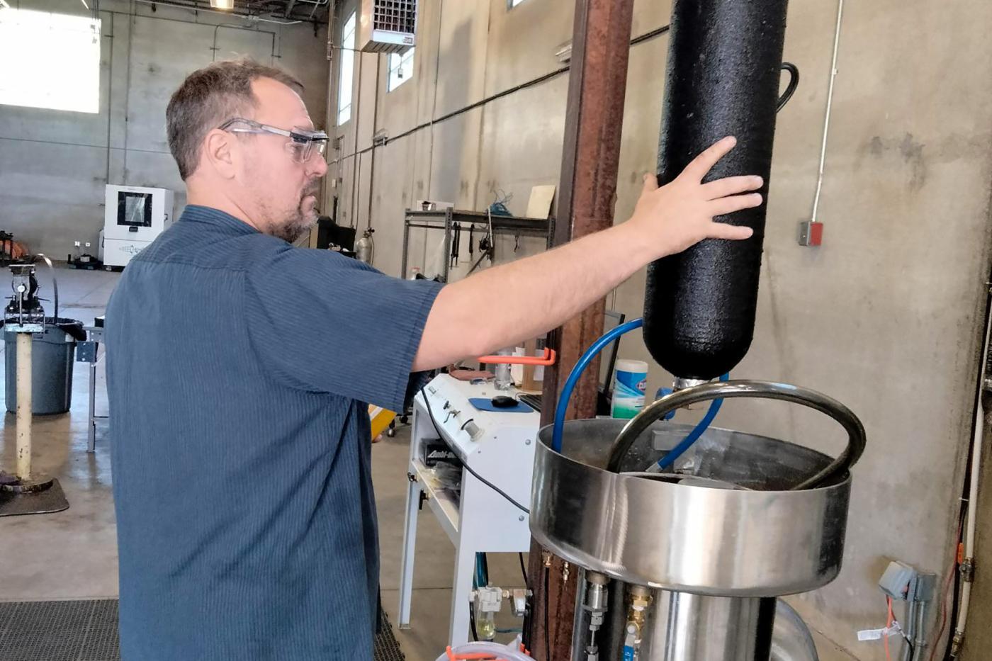 Technician performing hydrostatic testing on a composite pressure vessel in a lab setting, demonstrating Steelhead’s recertification services that verify safety, extend vessel life, and ensure compliance with industry codes.