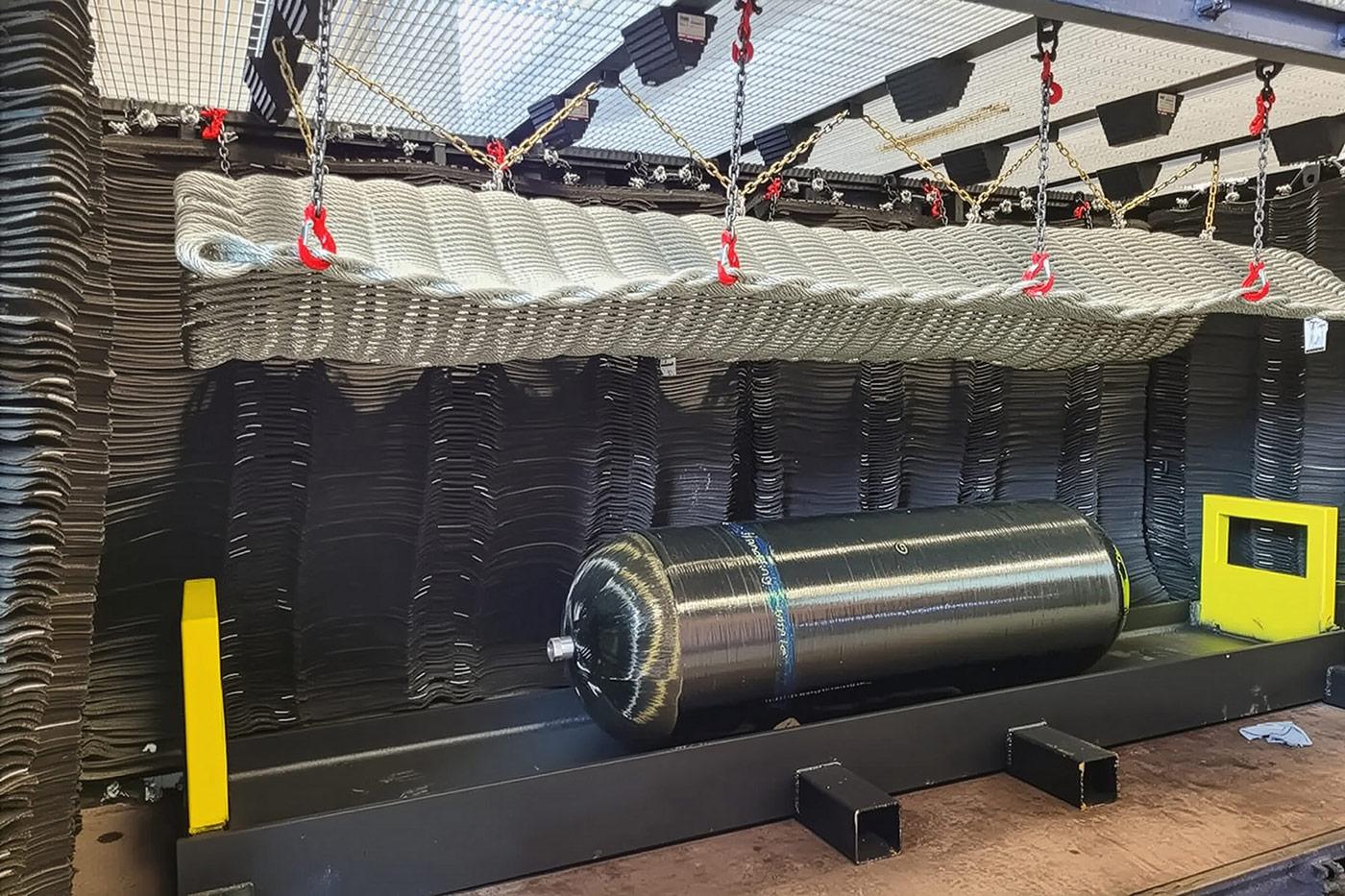 Composite pressure vessel secured inside a controlled burst testing rig, illustrating Steelhead’s recertification and testing services that maintain DOT compliance and extend vessel service life in regulated applications.