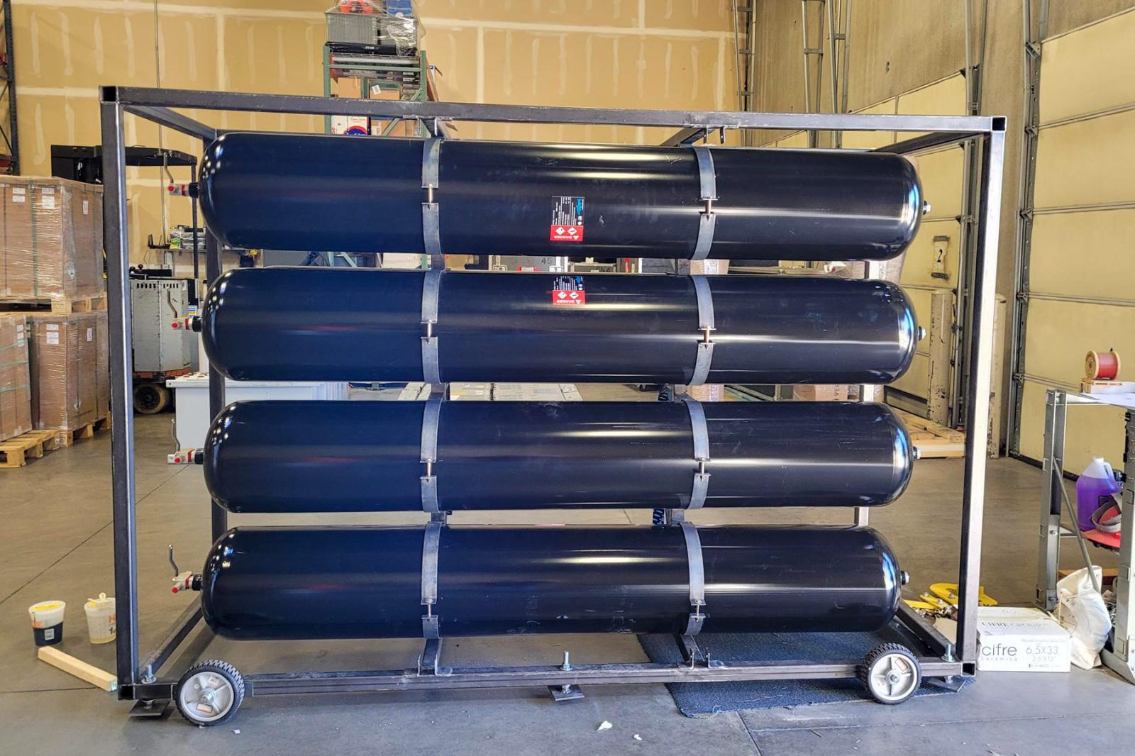 Multiple-element gas container (MEGC) with low-pressure Type 1 cylinders used for hydrogen storage prior to compression.