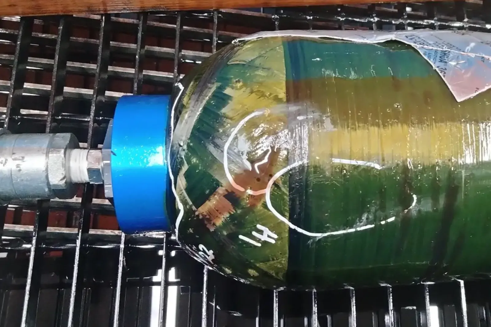 Composite pressure vessel connected to a high-pressure cycle tester for validation at up to 10,000 psi with precise pressure control and electronic monitoring.