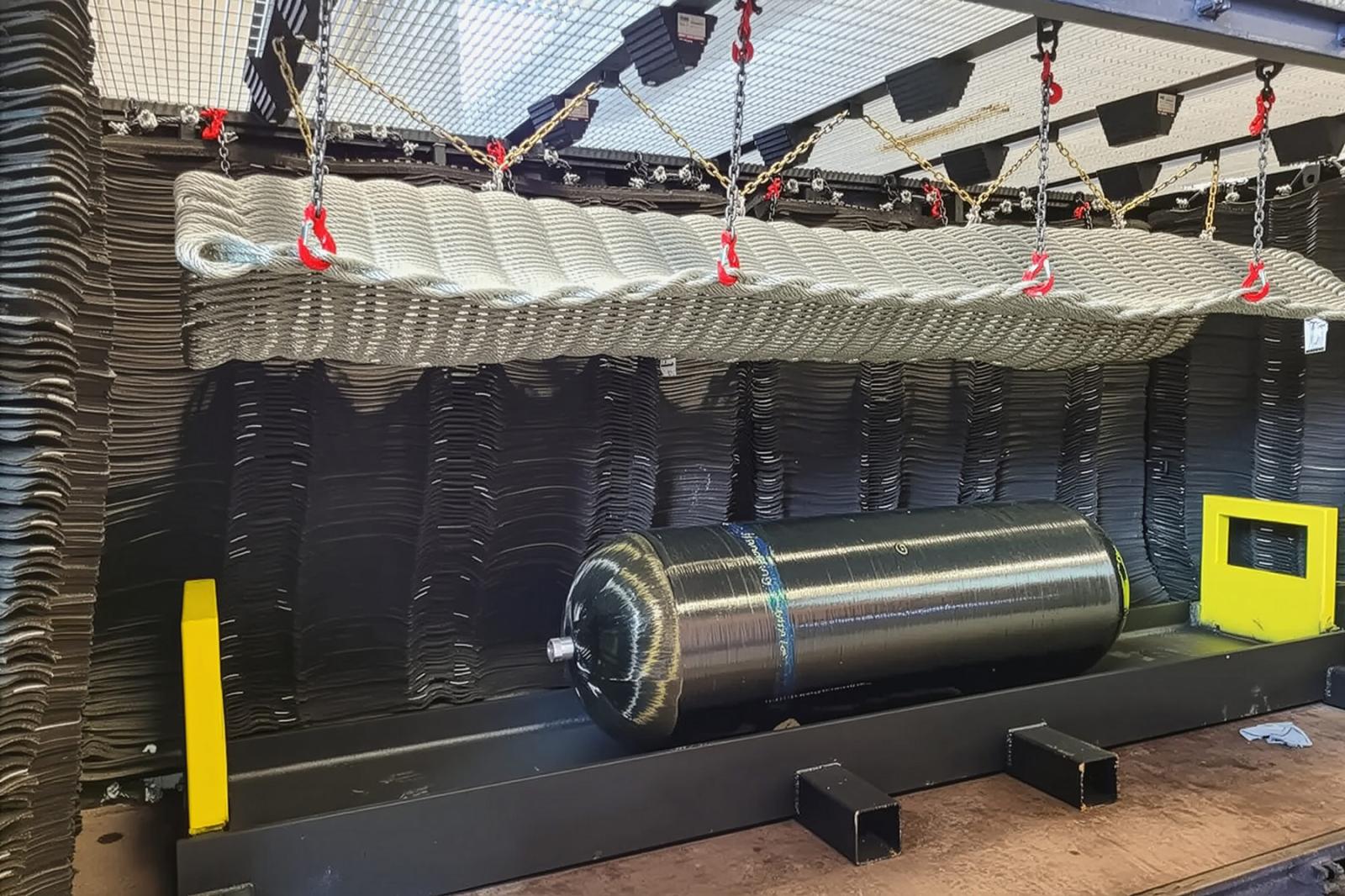 Composite pressure vessel positioned inside Steelhead Composites’ burst testing rig, rated to 30,000 psi, with strain gage mounting and continuous pressure vs. strain data collection.
