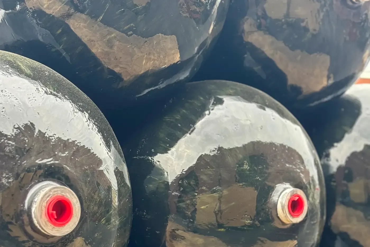 Close-up of composite pressure vessels with visible valve ports, representing safe and efficient gas storage solutions for medical gases, CNG refueling stations, and laboratory environments.