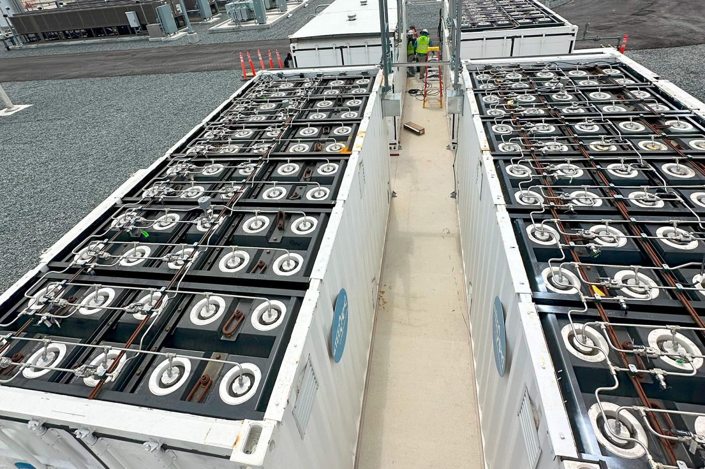 Overhead view of Steelhead Composites’ HydrogenCube energy storage containers with the roof removed, showing rows of integrated composite pressure vessels, piping, and fittings at an industrial installation site.